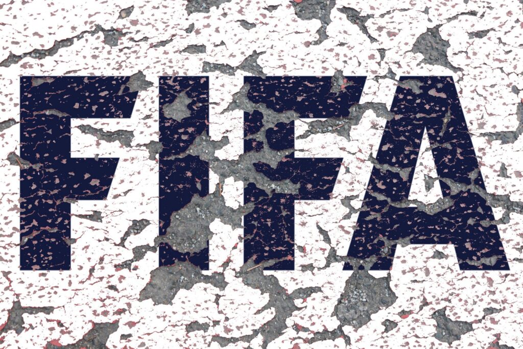 A photo of the FIFA logo on a wall where the paint is peeling off. Credit: CHROMORANGE / Ralph Peters / Alamy Stock Photo